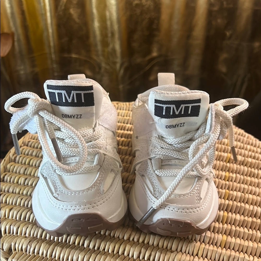TMT white tennis shoes